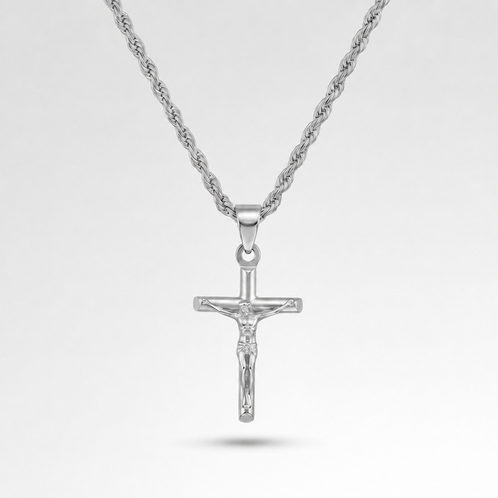Silver crucifix pendant on a chain against a light gray background