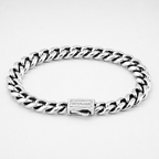 A silver-toned stainless steel curb link bracelet with a rectangular clasp engraved with the brand name 'OUTRAGE', shown on a clean white background.