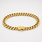 A gold-toned Cuban link chain bracelet with a rectangular clasp engraved with the brand name 'OUTRAGE', displayed on a clean white background.