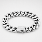 A silver-toned Cuban link chain bracelet with a polished rectangular clasp engraved with the brand name 'OUTRAGE', shown on a light gray background.