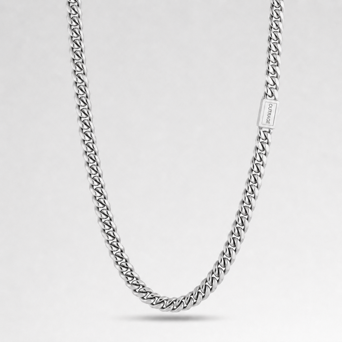 A silver-toned curb chain necklace with a rectangular clasp engraved with the brand name 'JEWELRY', displayed against a clean light gray background.