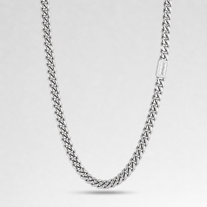 A silver-toned curb chain necklace with a rectangular clasp engraved with the brand name 'JEWELRY', displayed against a clean light gray background.
