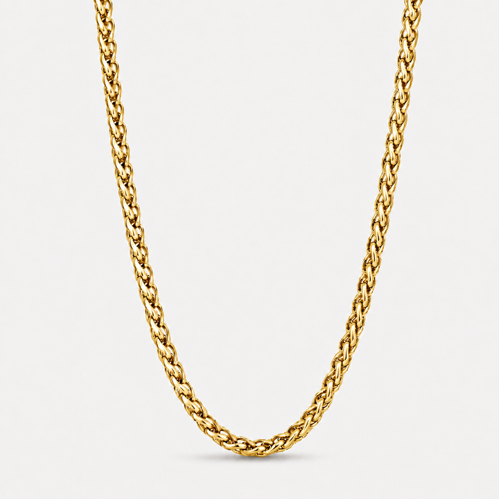 A close-up of a thick, polished yellow gold curb chain necklace forming a U-shape against a clean, light gray background.