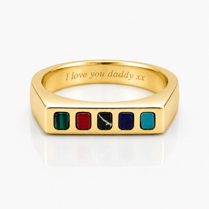 A gold signet-style ring with five small colored square inlays on the front and the engraved text 'I love you daddy xx' inside the band, shown on a clean white background.