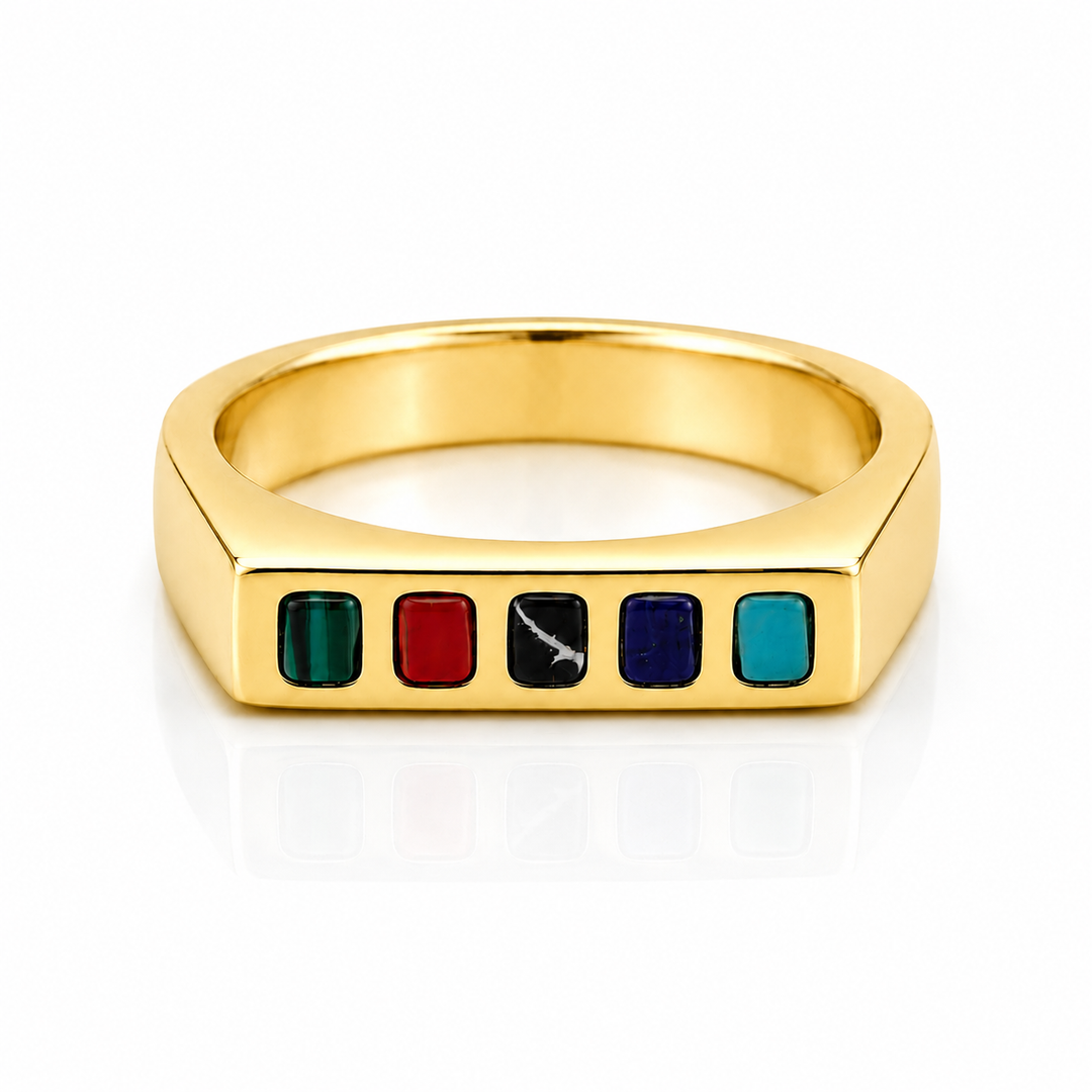 A gold signet-style ring featuring five small rectangular inlaid stones in green, red, black, blue, and teal, set against a clean white background.