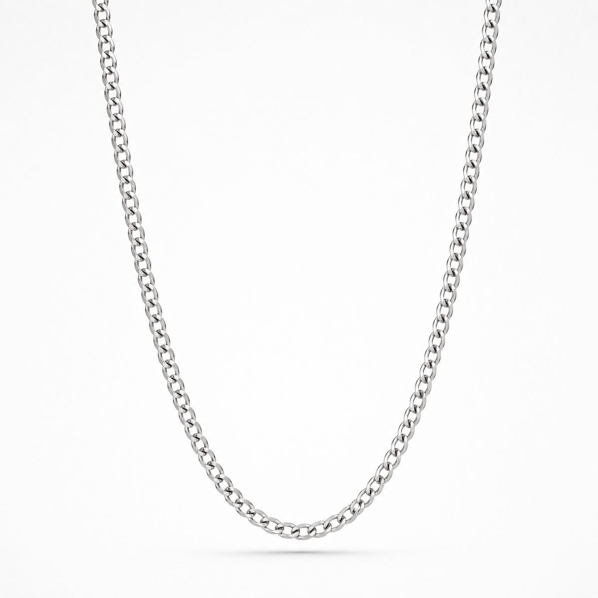 A classic silver-toned curb link chain necklace, shown draped in a U-shape against a clean white background.