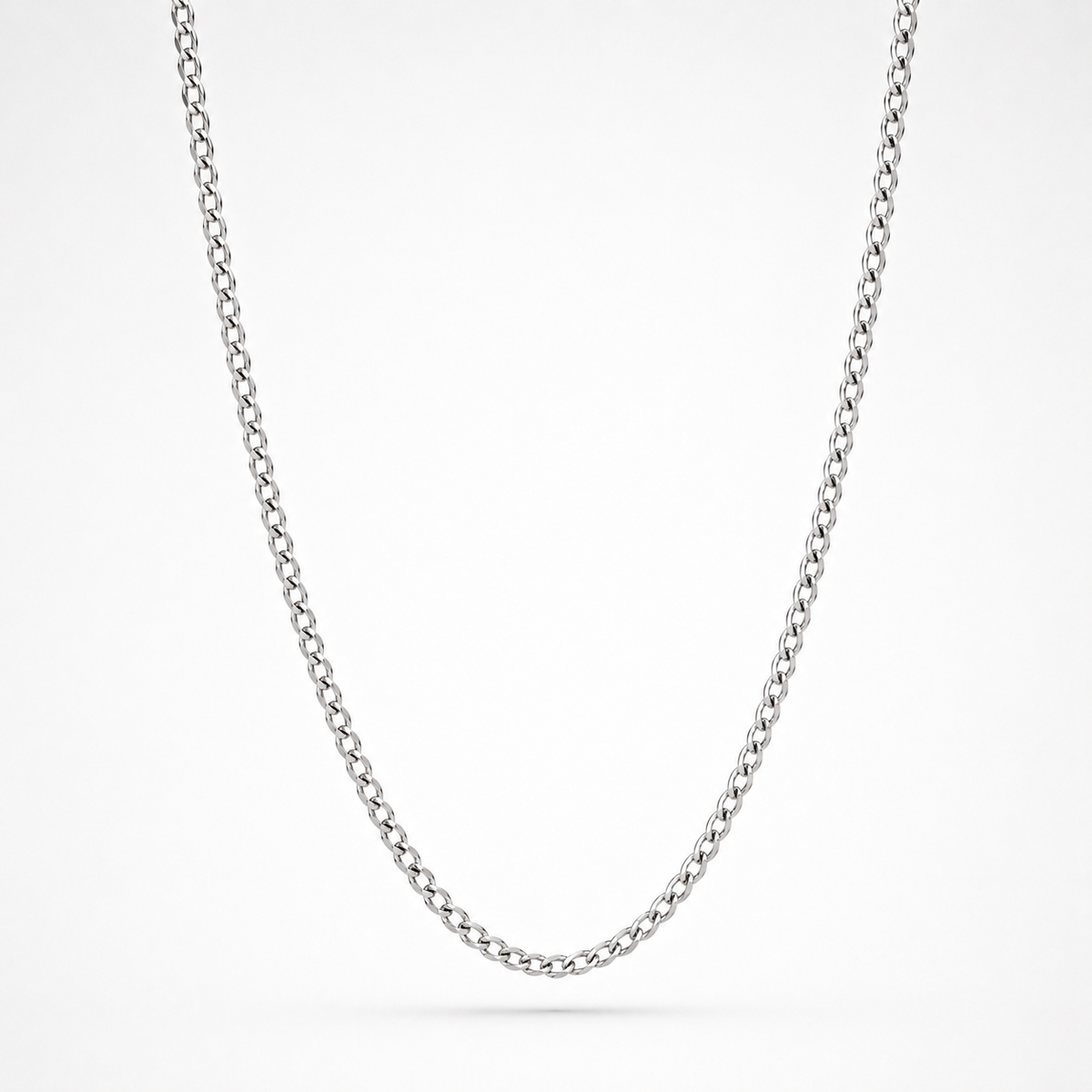 A classic silver curb chain necklace shown in a clean studio setting against a white background.