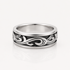 A silver band ring with a polished finish and an engraved black scrollwork pattern, shown on a clean white background with a soft reflection.