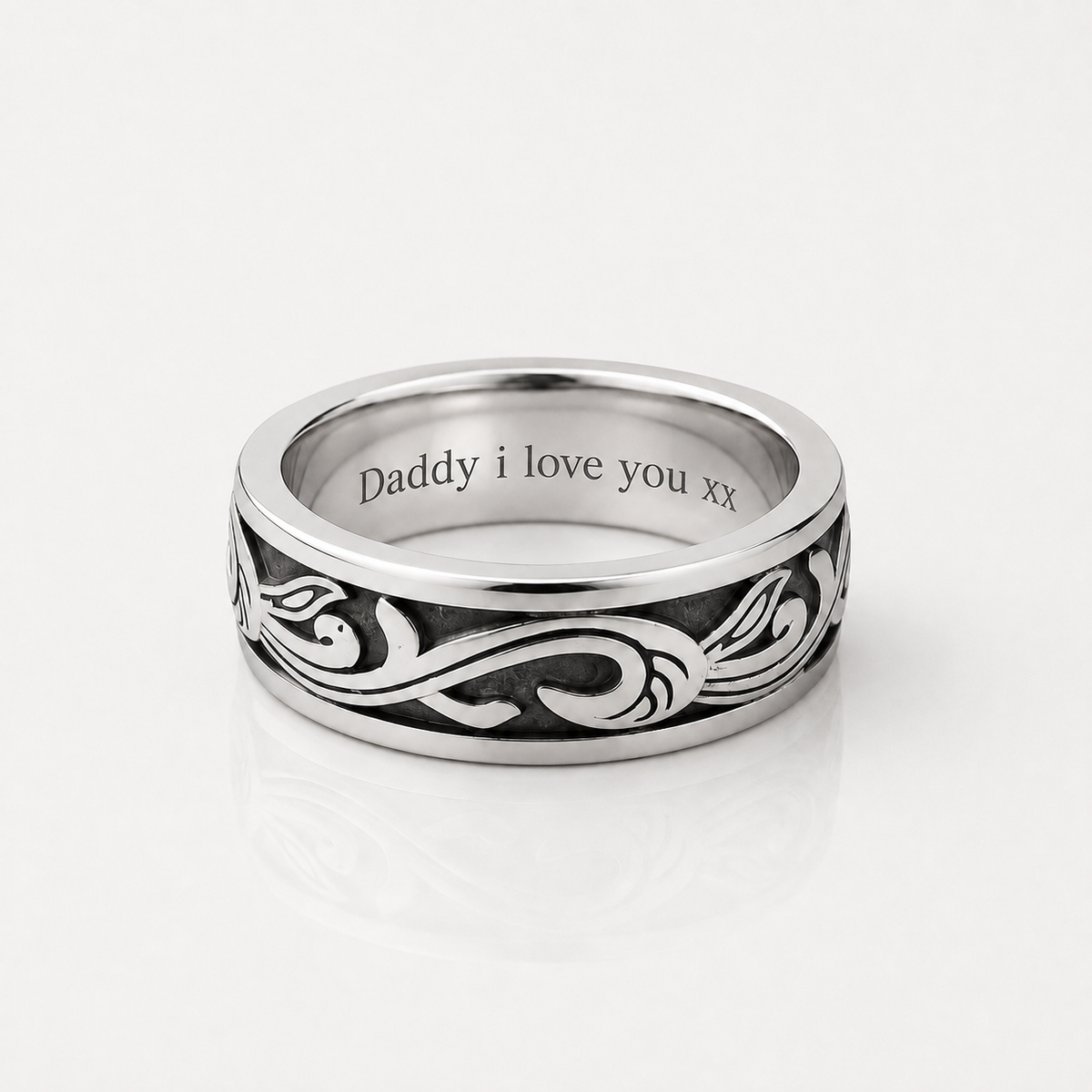 A silver band ring with an engraved black scroll pattern and the text 'Daddy i love you xx' inside, shown on a clean white background.