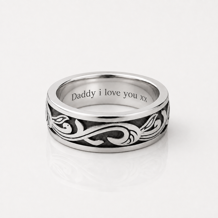 A silver band ring with an engraved black scroll pattern and the text 'Daddy i love you xx' inside, shown on a clean white background.