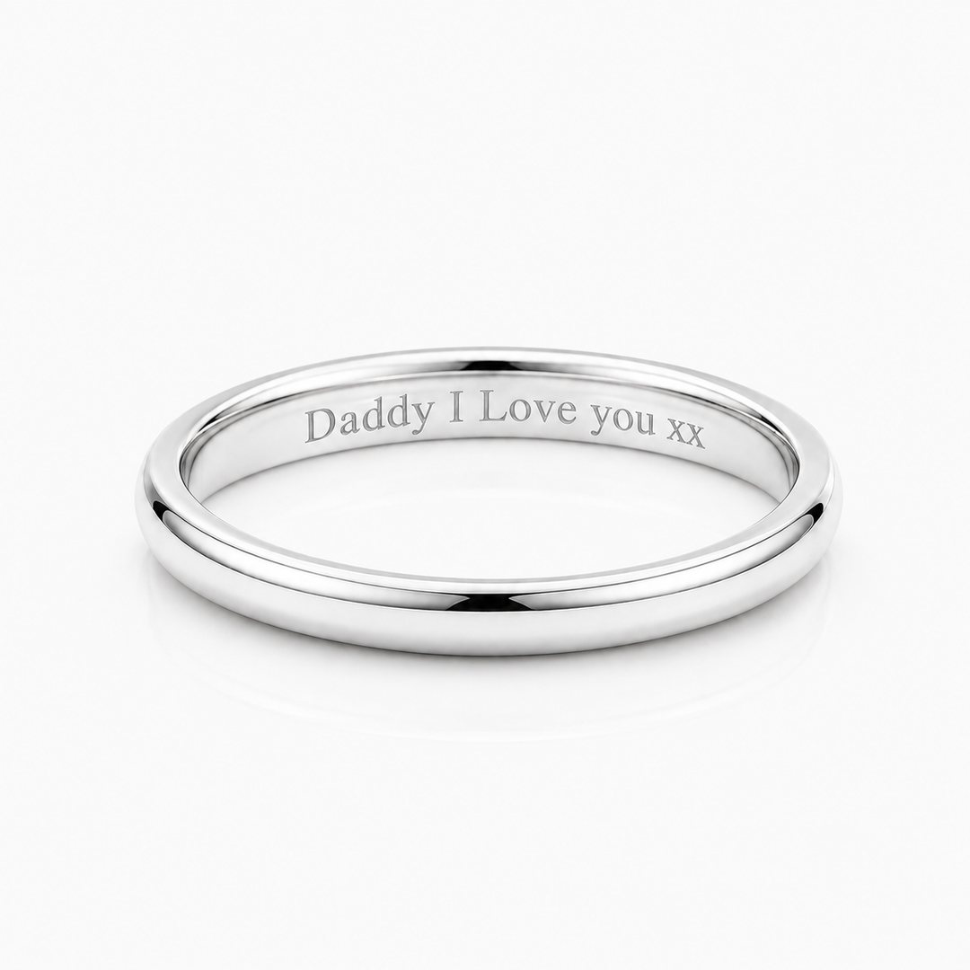 A polished silver band ring engraved with the message 'Daddy I Love you xx' on a clean white background.