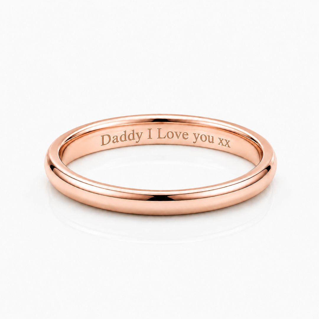 A polished rose gold band ring engraved with 'Daddy I Love you xx' on the inside, shown on a clean white background.