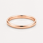 A minimalist rose gold band ring with a smooth, polished finish, shown on a clean white reflective surface.