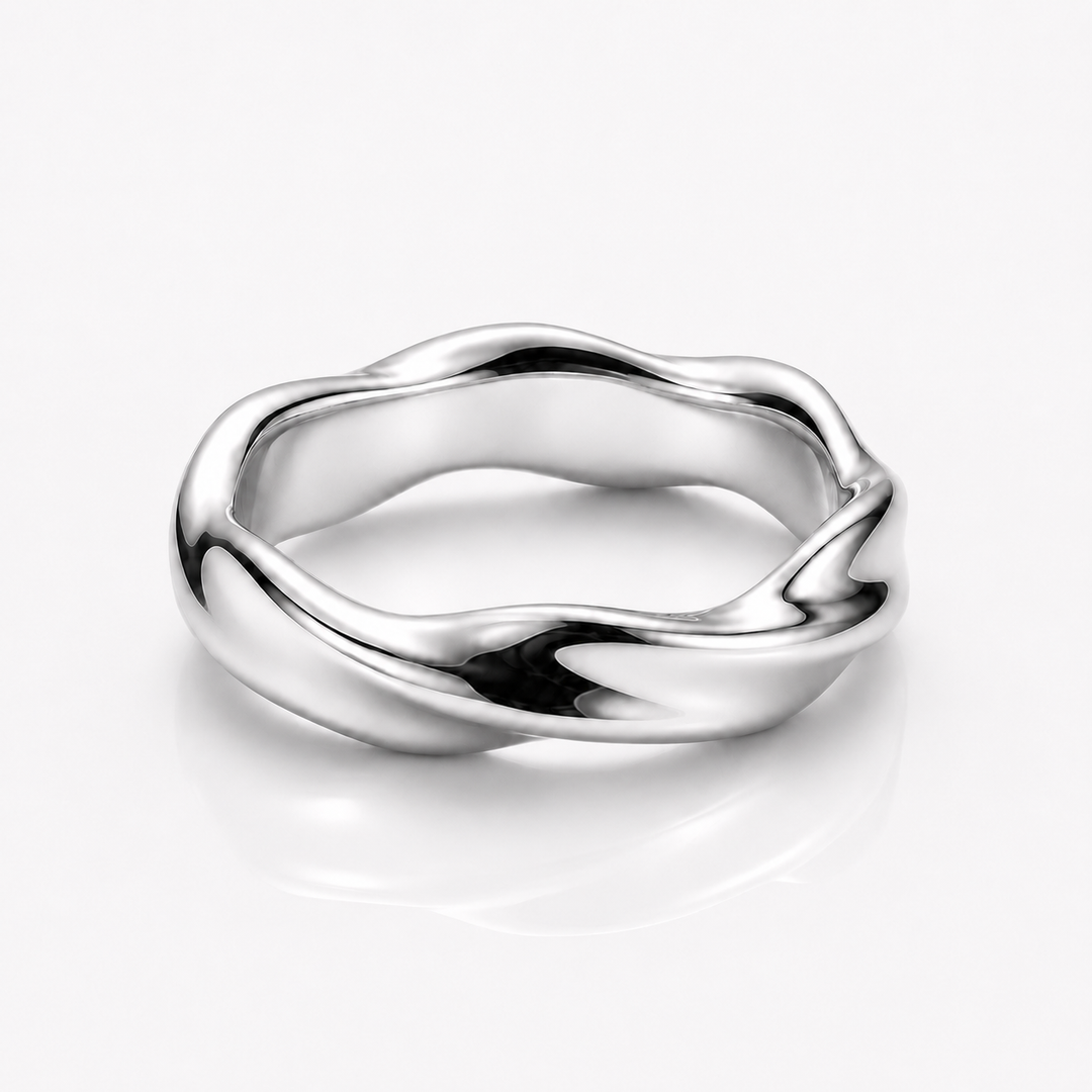 A polished silver ring with a wavy, fluid organic shape, shown on a clean white background with a soft reflection underneath.