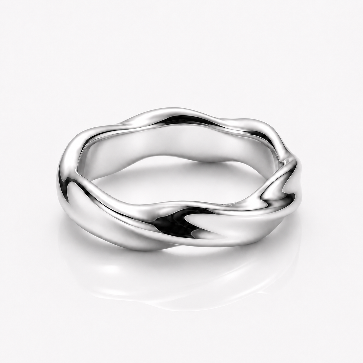 A polished silver ring with a wavy, fluid organic shape, shown on a clean white background with a soft reflection underneath.