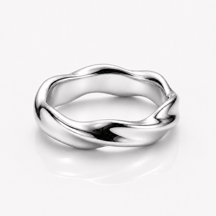 A polished silver ring with a wavy, fluid organic shape, shown on a clean white background with a soft reflection underneath.