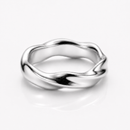 A polished silver ring with a wavy, fluid organic shape, shown on a clean white background with a soft reflection underneath.
