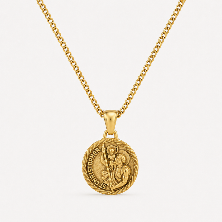 A gold pendant necklace featuring a circular Saint Christopher medal on a matching chain, set against a clean off-white background.