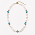 A pearl beaded necklace with turquoise blue beads and gold spacer accents, displayed on a clean white background.