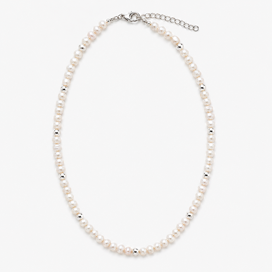 A classic pearl necklace with small white pearls and silver spacer beads, featuring a silver clasp and extender chain, shown on a light gray background.