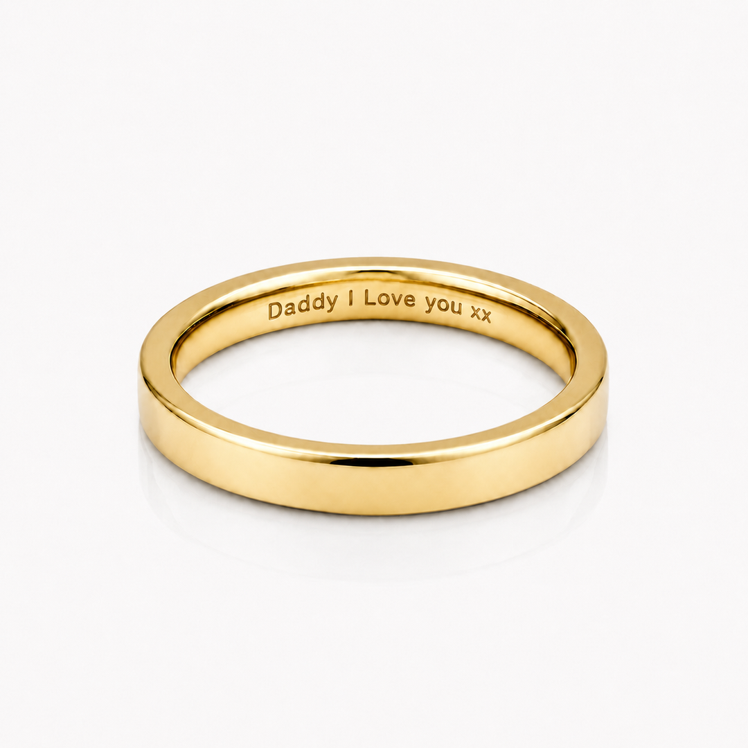 A polished yellow gold band ring engraved with 'Daddy I Love you xx' on a clean white background.