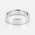 A polished silver band ring with the word 'OUTRAGE' engraved inside, shown on a clean white reflective surface.