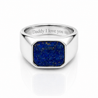 A silver signet ring featuring a square blue lapis lazuli stone face, with 'Daddy I love you xx' engraved on the inside band, set against a clean white background with a soft reflection.