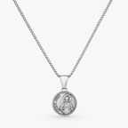A silver chain necklace with a round, detailed religious pendant, shown against a light gray background.