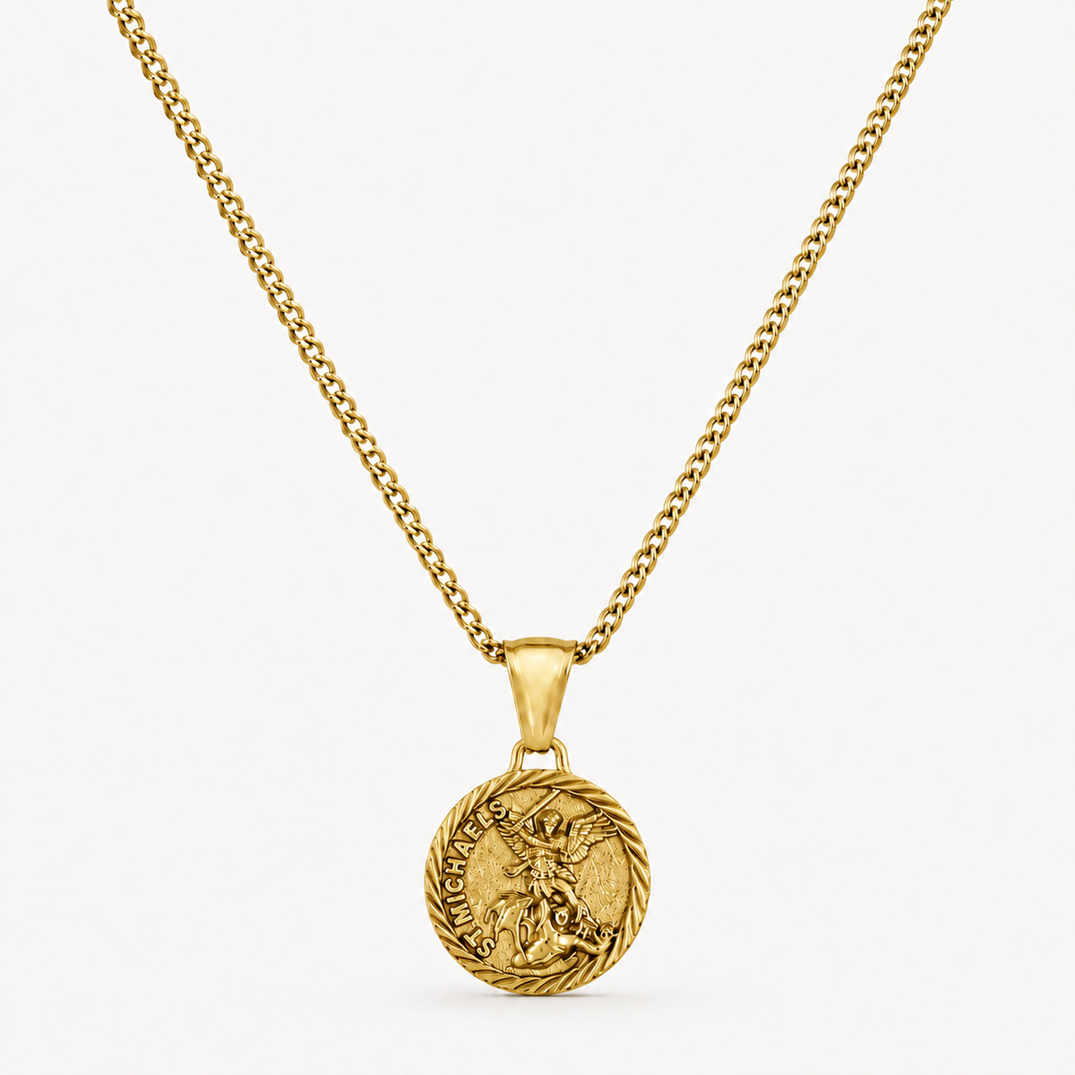 A gold chain necklace with a round medallion pendant featuring a detailed figure and engraved text, displayed against a clean off-white background.