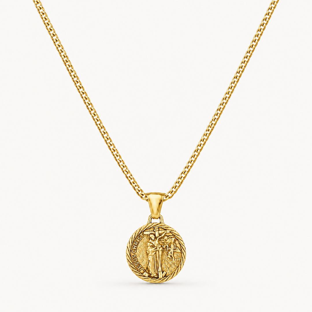A gold chain necklace with a circular medallion pendant featuring an embossed figure, shown against a clean off-white background.