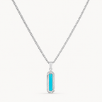 A silver-toned chain necklace with a vertical rectangular pendant featuring a bright turquoise blue center, shown on a clean off-white background.