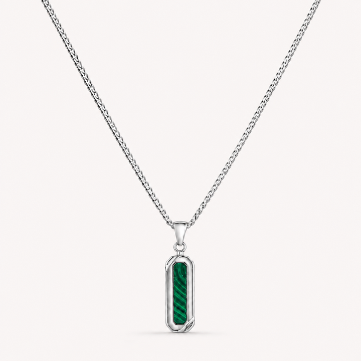 A silver-toned chain necklace with a vertical rectangular pendant featuring a textured green inlay, shown on a light off-white background.