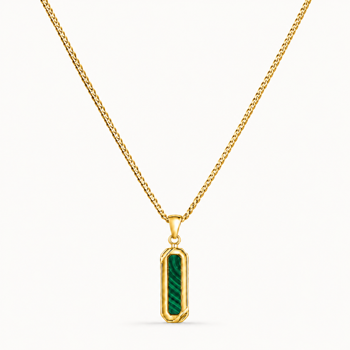 A gold chain necklace with a vertical rectangular pendant featuring a green striped inlay, shown against a plain white background.