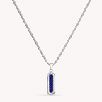 A silver-toned chain necklace with a vertical rectangular pendant featuring a deep blue textured center, shown on a light off-white background.