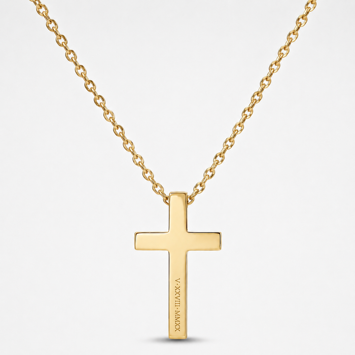 A gold cross pendant necklace with a matching gold chain, shown against a light gray background. The pendant features the engraved text 'JESUS IS THE ONLY WAY'.