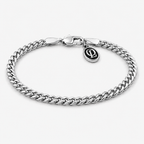 A silver-toned curb link chain bracelet with a spring-ring clasp and a small oval charm featuring an interlocking 'P' logo, shown on a light gray background.