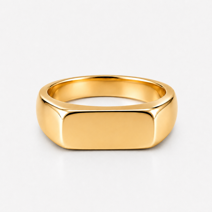 A polished yellow gold signet ring with a flat, rectangular face, shown on a clean white background.