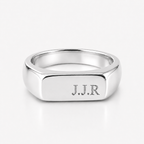 A polished silver signet ring with the engraved initials 'J.J.R' on the face, shown on a clean white background.