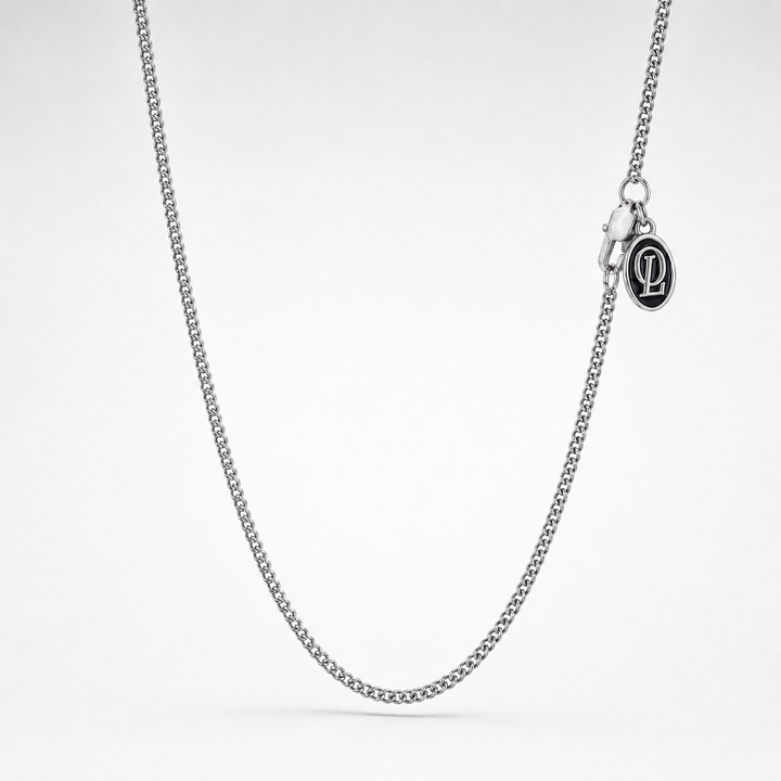 Silver chain necklace on a light gray background