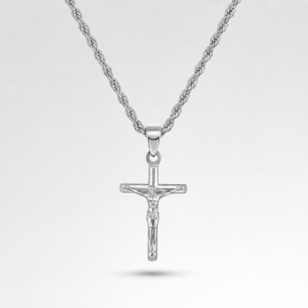 Silver crucifix pendant on a chain against a light gray background