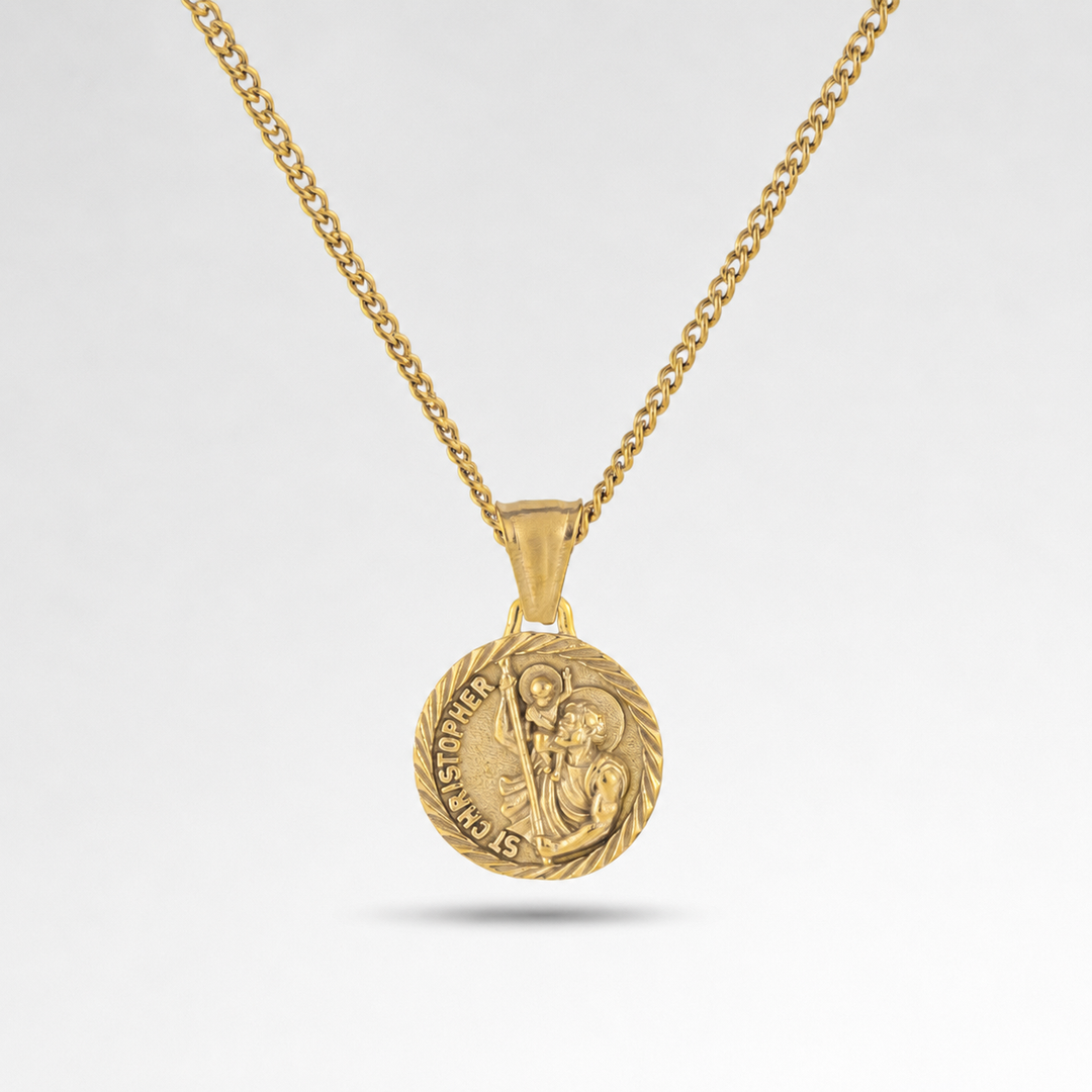 Gold necklace with a round pendant on a light gray background