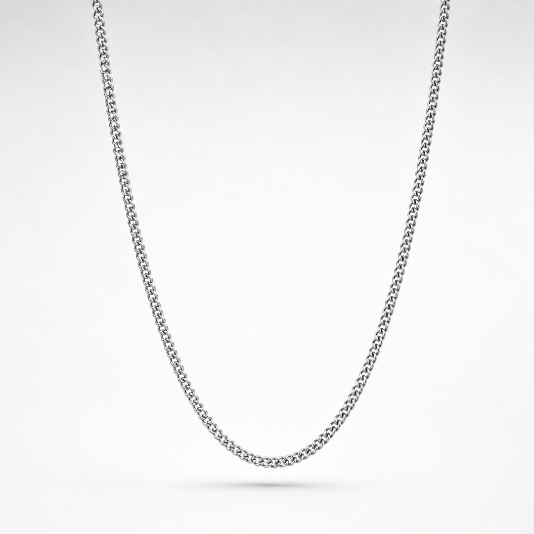 Silver chain necklace on a light gray background