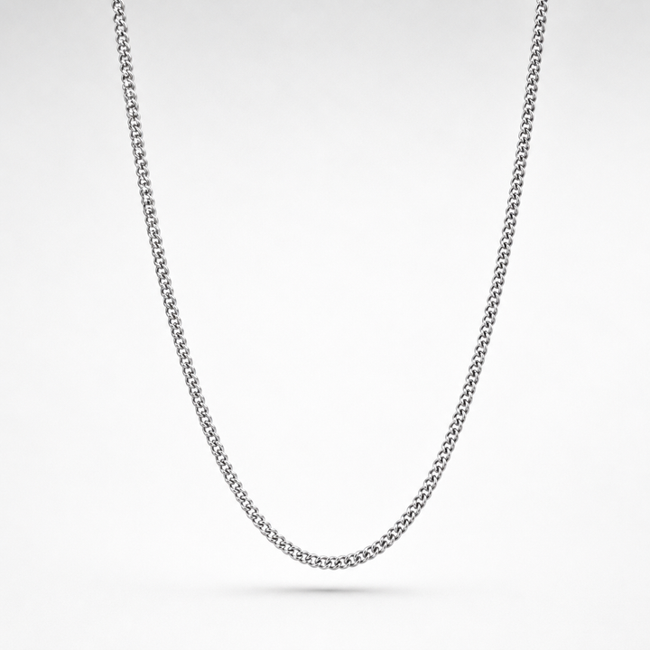 Silver chain necklace on a light gray background