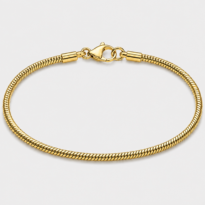A gold-toned metal chain bracelet with a lobster clasp, shown in a circular loop on a light gray background.