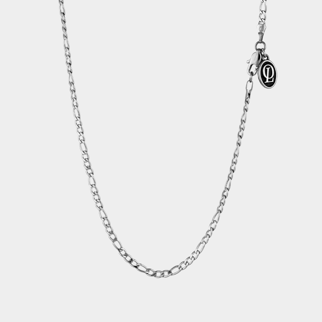 Silver chain necklace on a light gray background