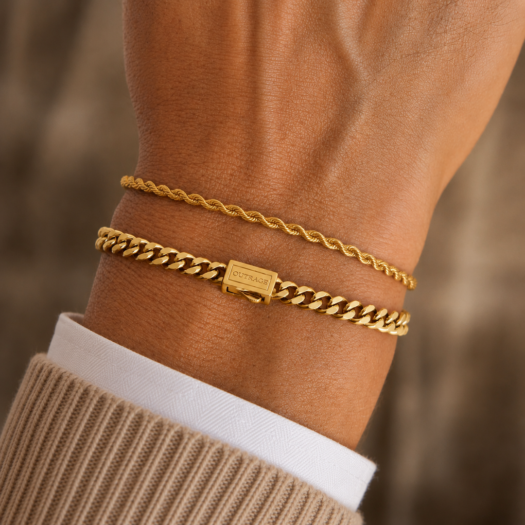Two gold bracelets on a person's wrist, including a thin twisted rope-style chain and a thicker curb chain with a rectangular clasp engraved with 'CARMEN'.