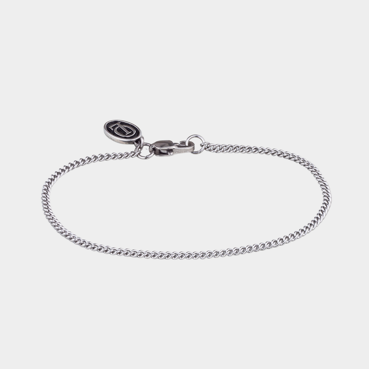 Silver bracelet on a light gray background