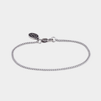Silver bracelet on a light gray background
