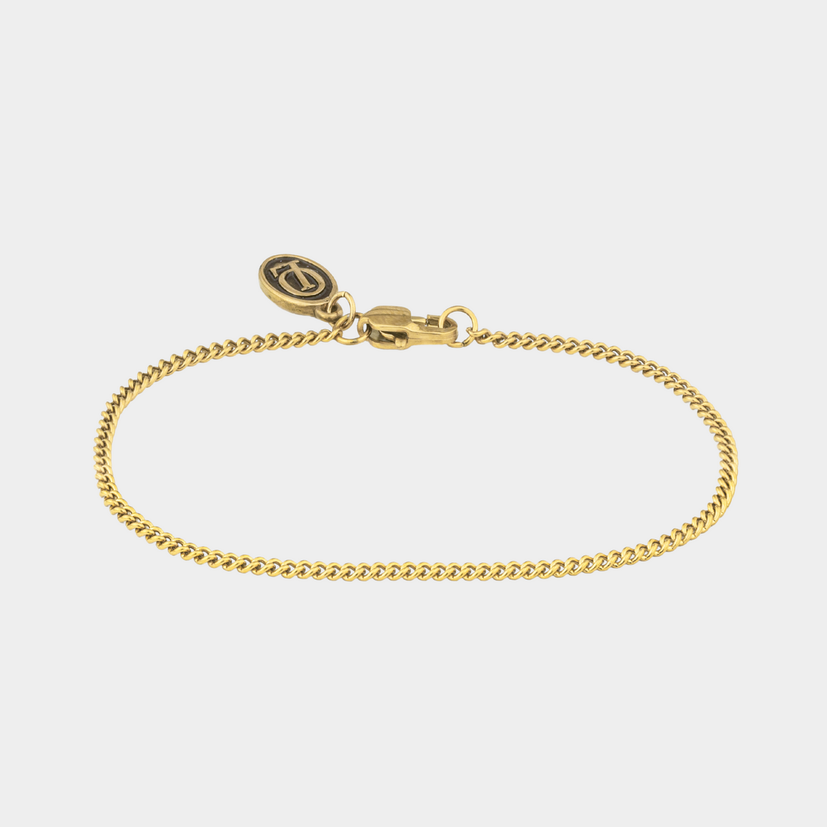 Gold bracelet on a light gray background