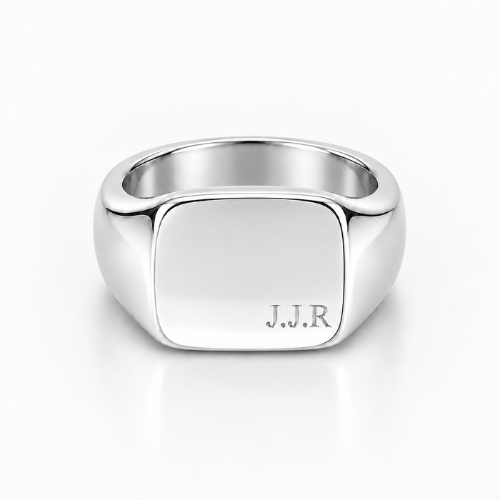 A polished silver signet ring with a square face engraved with the initials 'J.J.R', shown on a clean white background.